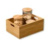 A bamboo storage box containing three glass jars filled with cereal or granola. Produktbild-Vorschau