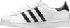 A side view of a white Adidas Superstar sneaker with black stripes. Podgląd zdjęcia produktu