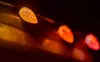 A close-up, shallow depth of field shot of a string of Christmas lights in warm colors. Náhled obrázku produktu