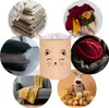 A collage of various items including folded blankets, pillows, clothing, a hat, stuffed animals, and a laundry basket with a cat face design. Produktbild-Vorschau