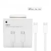 A white box with Apple branding and product information, alongside two white USB-C cables. Produktbild-Vorschau