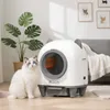 A cat sits next to an automatic self-cleaning litter box in a modern living room. Produktbild-Vorschau