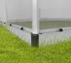 Close-up view of the base and corner of a greenhouse structure, with grass in the foreground. Produktbild-Vorschau