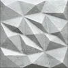 A close-up, top-down view of a 3D decorative wall panel with a geometric, faceted design. Anteprima dell’immagine prodotto