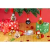 Christmas tree ornaments shaped like small glass bottles filled with liquid, placed on a wooden surface with gift boxes and festive decorations. Anteprima dell’immagine prodotto