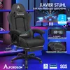 A gaming chair is shown in a room with computer monitors in the background. Produktbild-Vorschau