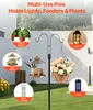 A multi-use pole in a garden setting, demonstrating various items that can be hung from it, including potted plants, a bird feeder, a lantern, wind chimes, and a lamp. Produktbild-Vorschau