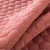 A close-up shot of a pink, textured fabric with a hexagonal pattern. Náhled obrázku produktu