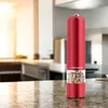 A red electric pepper grinder filled with peppercorns sits on a granite countertop in a kitchen. Náhled obrázku produktu