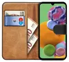 A book-style phone case with slots for cards and cash, shown open with a smartphone inside. Podgląd zdjęcia produktu