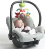A baby is sitting in a car seat with a mobile hanging above it. Voir les images du produit