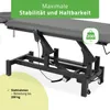 A close-up, angled view of a gray and black adjustable treatment table. Produktbild-Vorschau