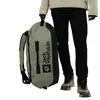 A person holding a duffel bag. Produktbild-Vorschau