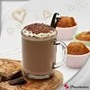 A mug of hot chocolate with whipped cream and chocolate shavings, served with muffins and chocolate pieces. Produktbild-Vorschau