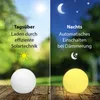 Split image showing a solar light ball in daytime and nighttime settings. Produktbild-Vorschau