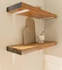 Two wooden shelves mounted on a wall, decorated with minimalist items. Produktbild-Vorschau
