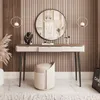 A vanity table setup with a mirror, stool, and decorative items. Produktbild-Vorschau
