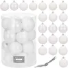 A collection of white Christmas ornaments in a clear plastic container, with additional ornaments displayed around it. Náhľad obrázku produktu
