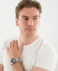 A man wearing a white t-shirt and a watch. Náhled obrázku produktu