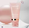 A pink tube of Medicube Collagen Night Wrapping Mask is displayed against a soft, blurred background of pink and white spheres, with a small airplane icon in the lower right corner and a South Korean flag in the lower left. Produktbild-Vorschau