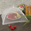 A food cover is placed over a plate of fruit on a kitchen counter. Produktbild-Vorschau