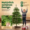 A child stands next to a Christmas tree, with a close-up of pine needles in the foreground. Produktbild-Vorschau