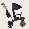 A side view of a black children's tricycle with a navy blue canopy and seat. Podgląd zdjęcia produktu