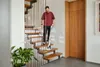 A man is cleaning a wooden staircase with a Kärcher floor cleaner. Náhľad obrázku produktu