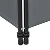 A close-up view of the bottom section of a dark gray room divider, showing the black metal poles and connectors. Produktbild-Vorschau