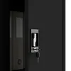 A close-up view of a black metal cabinet door with a silver handle and a key in the lock. Inside the cabinet, a few folders are visible. Voir les images du produit