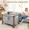 A baby is playing in a playpen while a woman sits on a couch nearby, using her phone. The scene is set in a living room. Náhled obrázku produktu