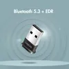 A Bluetooth adapter is shown floating against a background with concentric circles. Voir les images du produit