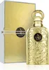 A gold-colored perfume bottle and its packaging are displayed against a white background. Náhled obrázku produktu