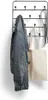 A black metal wall-mounted coat rack with a denim jacket and a canvas tote bag hanging on it. Produktbild-Vorschau
