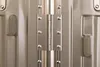 A close-up view of a metallic suitcase hinge and latches. Podgląd zdjęcia produktu