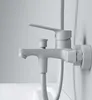 A close-up shot of a white bathtub faucet mounted on a wall. Produktbild-Vorschau