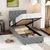 A bed with its storage compartment open, revealing stored items.