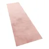 A pink runner rug is shown from a diagonal angle against a white background. Voir les images du produit