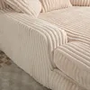 Close-up view of a beige corduroy sofa armrest and cushions. Náhled obrázku produktu