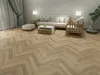 A living room scene with a sofa, coffee table, and armchair on a herringbone floor. Produktbild-Vorschau