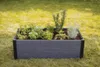 A raised garden bed filled with various herbs is placed on a grassy lawn. Náhľad obrázku produktu