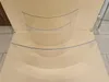 Three curved glass panels are displayed on a light beige surface. Náhľad obrázku produktu