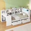 A white multifunctional bed with integrated desk and bookshelves, set against a backdrop of yellow and green walls. Produktbild-Vorschau