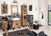 A bathroom with wooden furniture, a sink, a mirror, and a shower. Produktbild-Vorschau