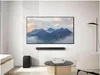 A modern living room with a Samsung soundbar and subwoofer mounted on the wall below a large TV displaying a landscape. Náhled obrázku produktu