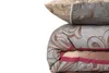 A stack of bedding, including a pillow and a duvet, with a floral pattern. Produktbild-Vorschau