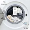 Laundry inside a washing machine with a product tag. Produktbild-Vorschau