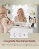 A woman is using a hair straightener in front of a vanity mirror with lights. A power strip with outlets and USB ports is shown below the vanity. Produktbild-Vorschau