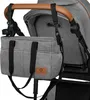 A close-up view of a gray stroller bag attached to the handle of a stroller. Anteprima dell’immagine prodotto