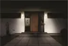 A modern house entrance at night, illuminated by outdoor wall lights. Voir les images du produit